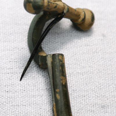 A bronze breast pin